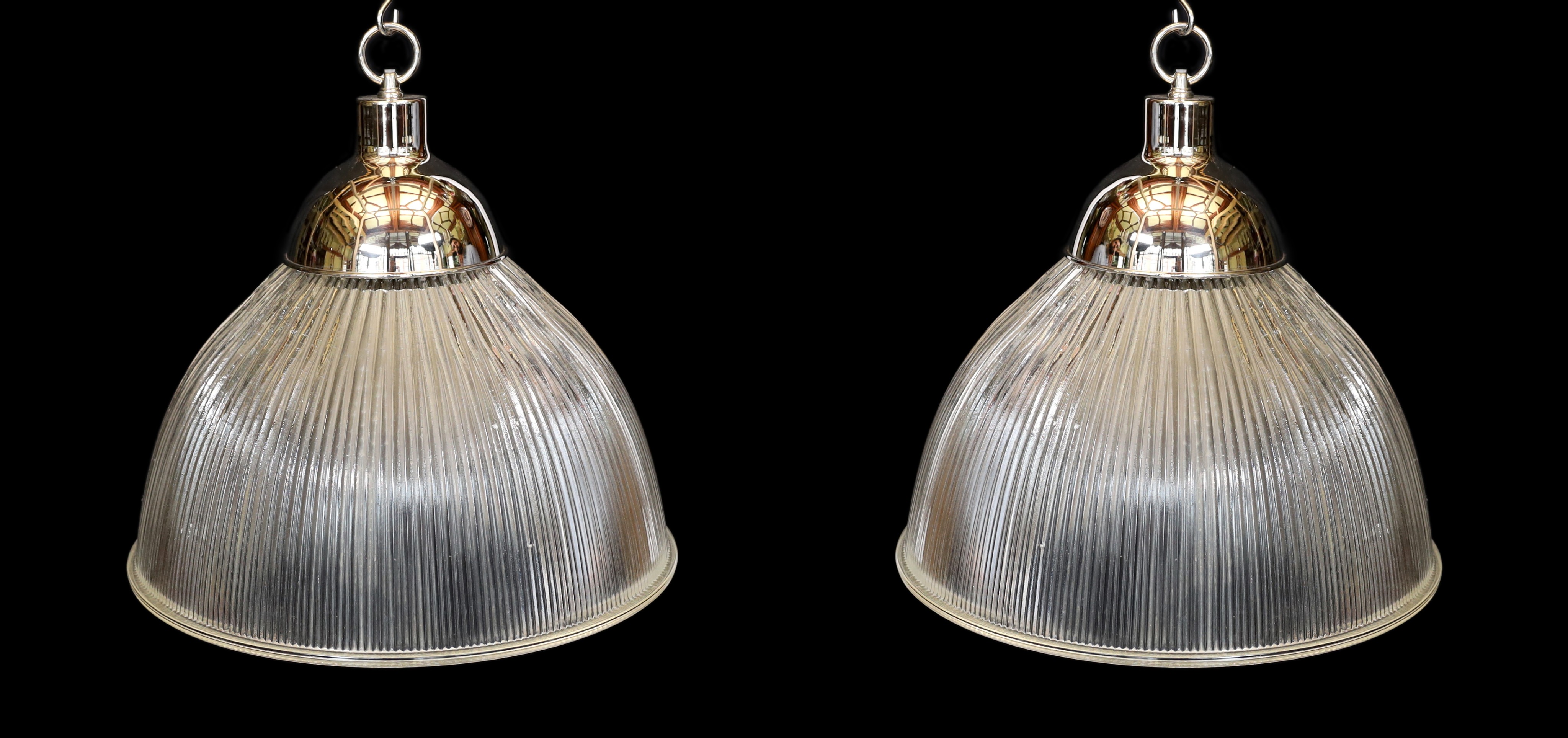 A pair of industrial style chrome plated ceiling lights with ribbed glass shades, signed Endural, diameter 46.5cm. height 50cm
